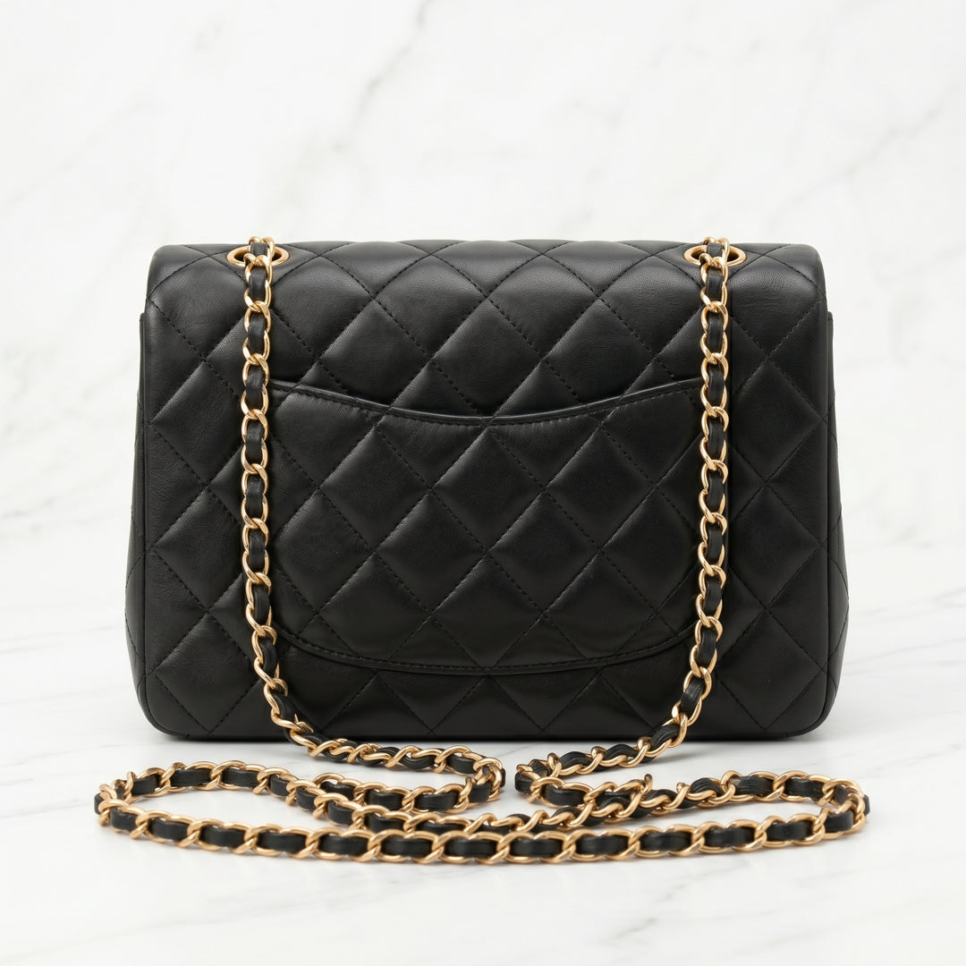 Black quilted handbag with gold chain strap back