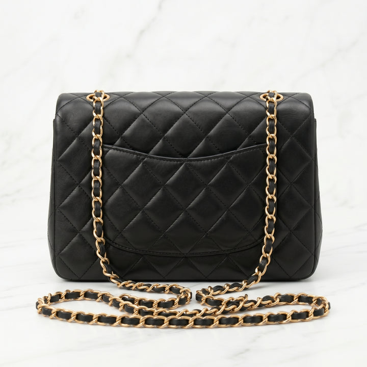 Black quilted handbag with gold chain strap back