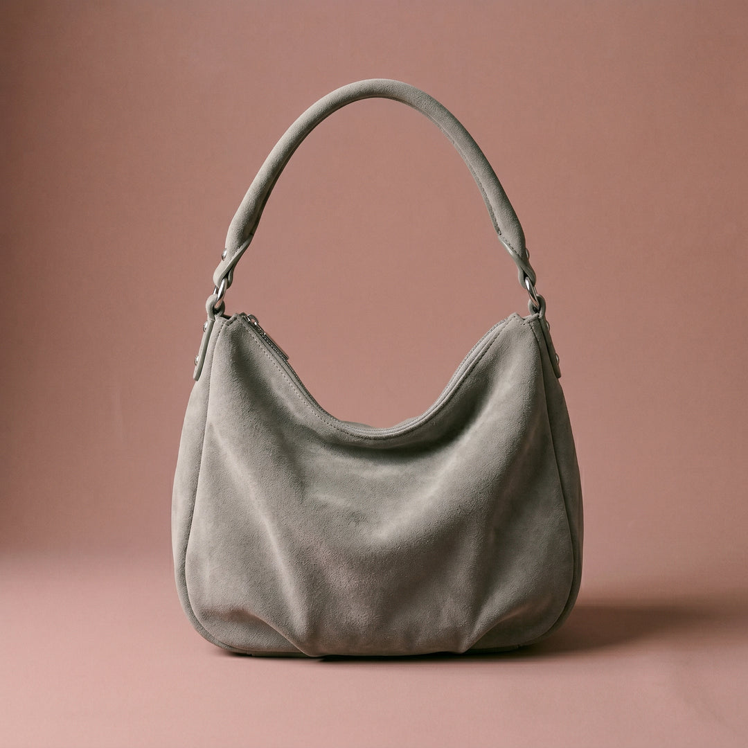 Gray handbag on a brown background