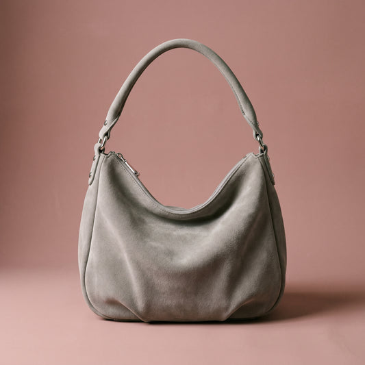 Gray handbag on a pink background
