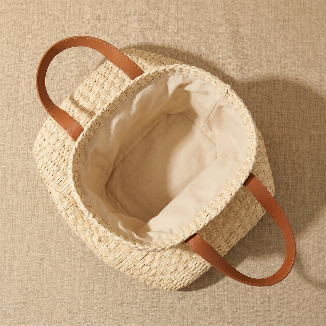Woven bag with leather handles inside