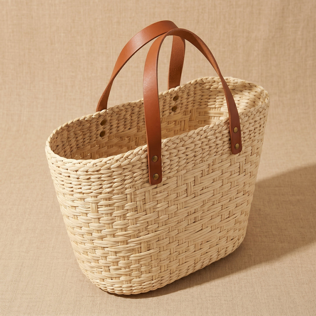 Woven basket with brown leather handles 